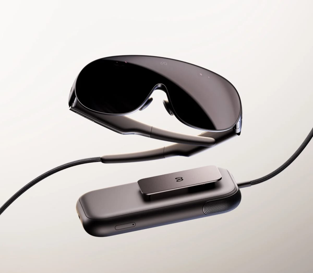 Meta VR Glasses, a slim dark visor with glasses-style arms, connected by a braided cable to a small rectangular compute puck